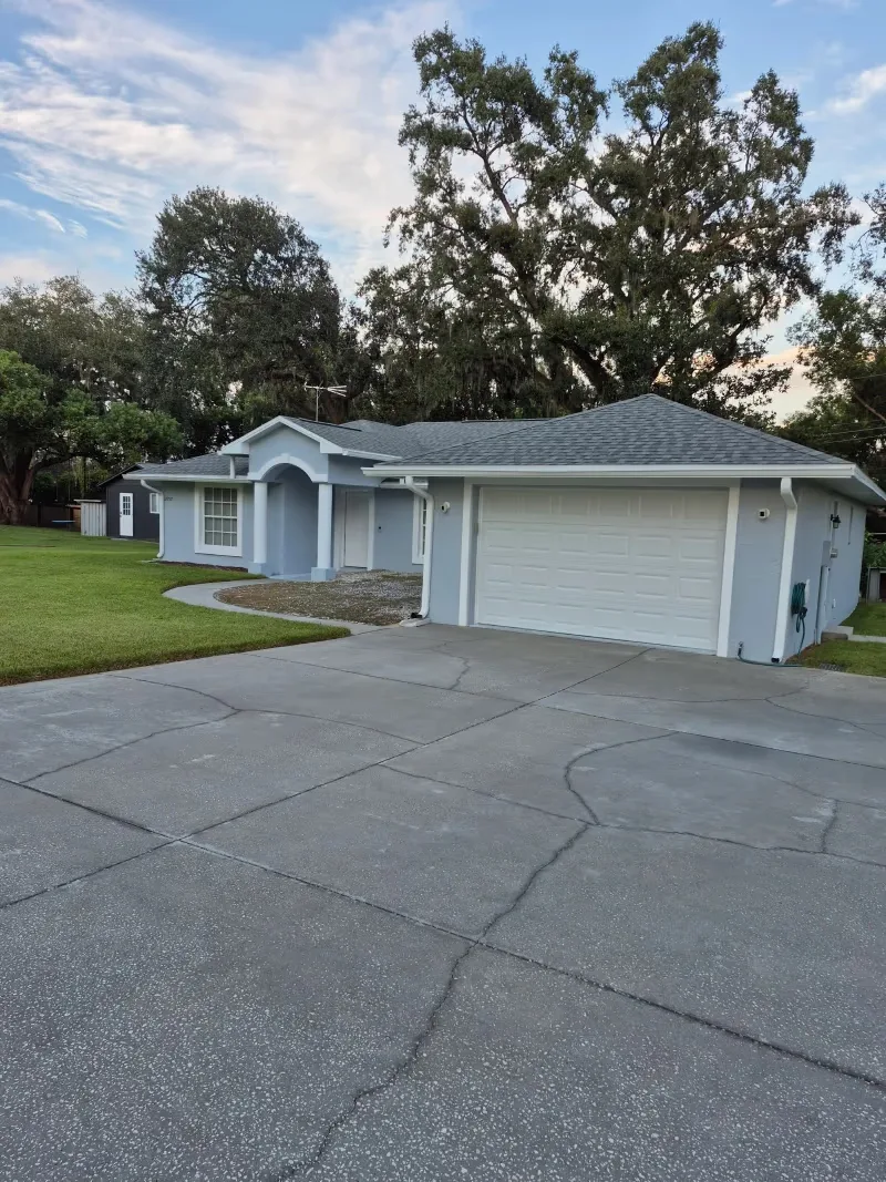 Freshly cleaned driveway in front of a blue Wesley Chapel home